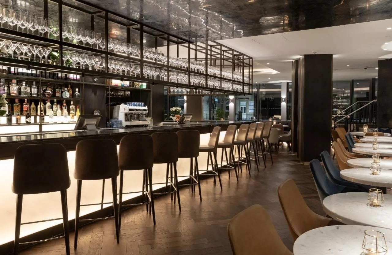 Bar with chairs and tables in the restaurant at voco Edinburgh - Haymarket by IHG
