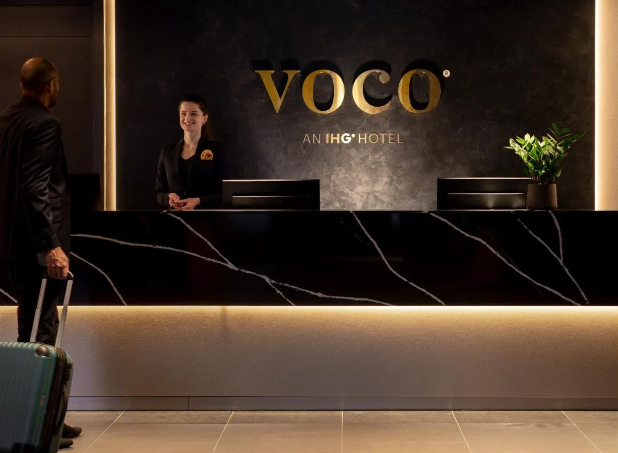 Staff member at the reception counter at voco Edinburgh - Haymarket by IHG